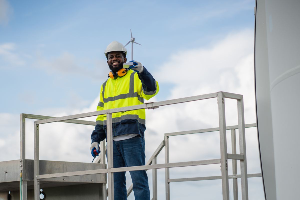 A technician on a turbine platform coordinating work by radio