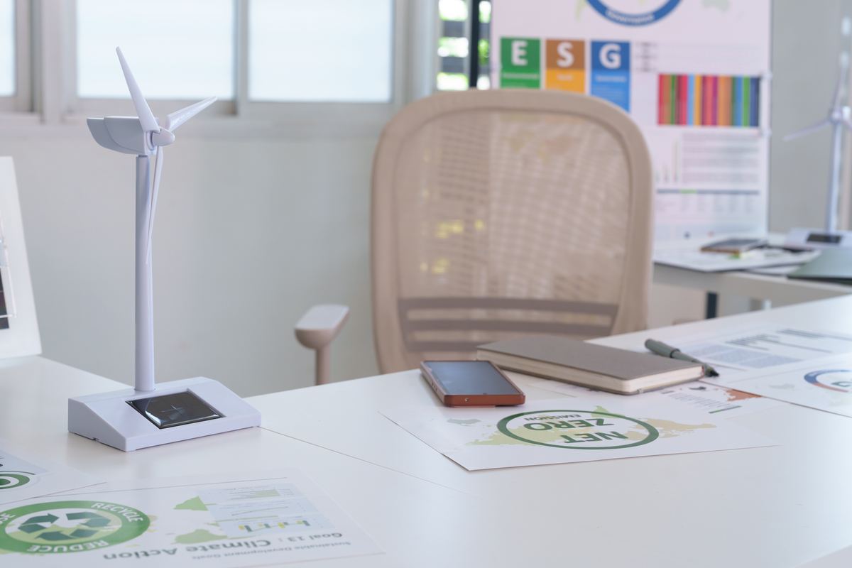 A desk with wind energy documentation, reports and a turbine model